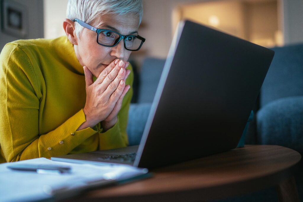 A woman looks at her laptop