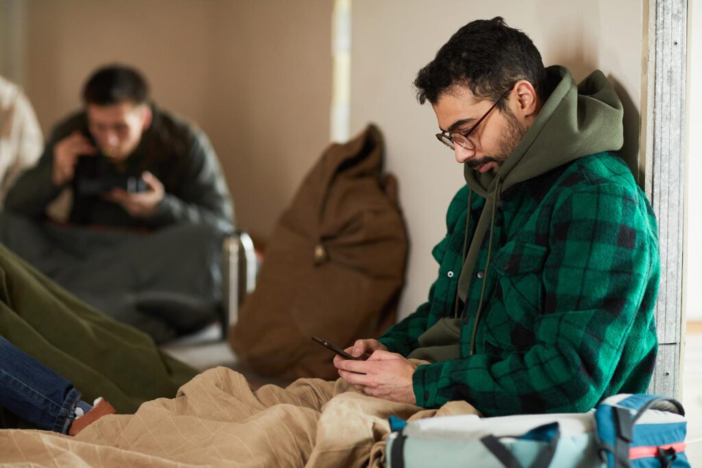 A man sits in an emergency shelter