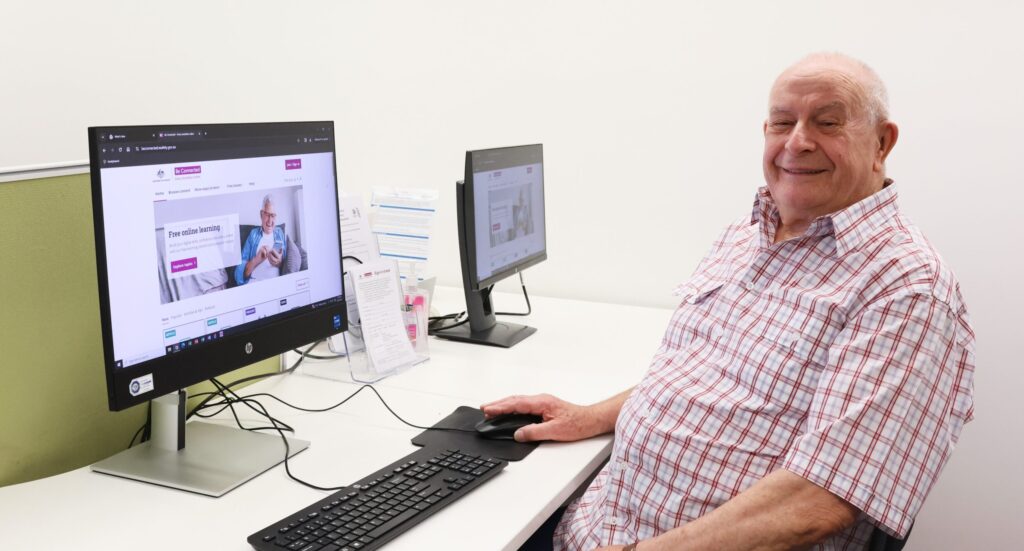 A men called Mike Garth looking at the camera when using a computer.