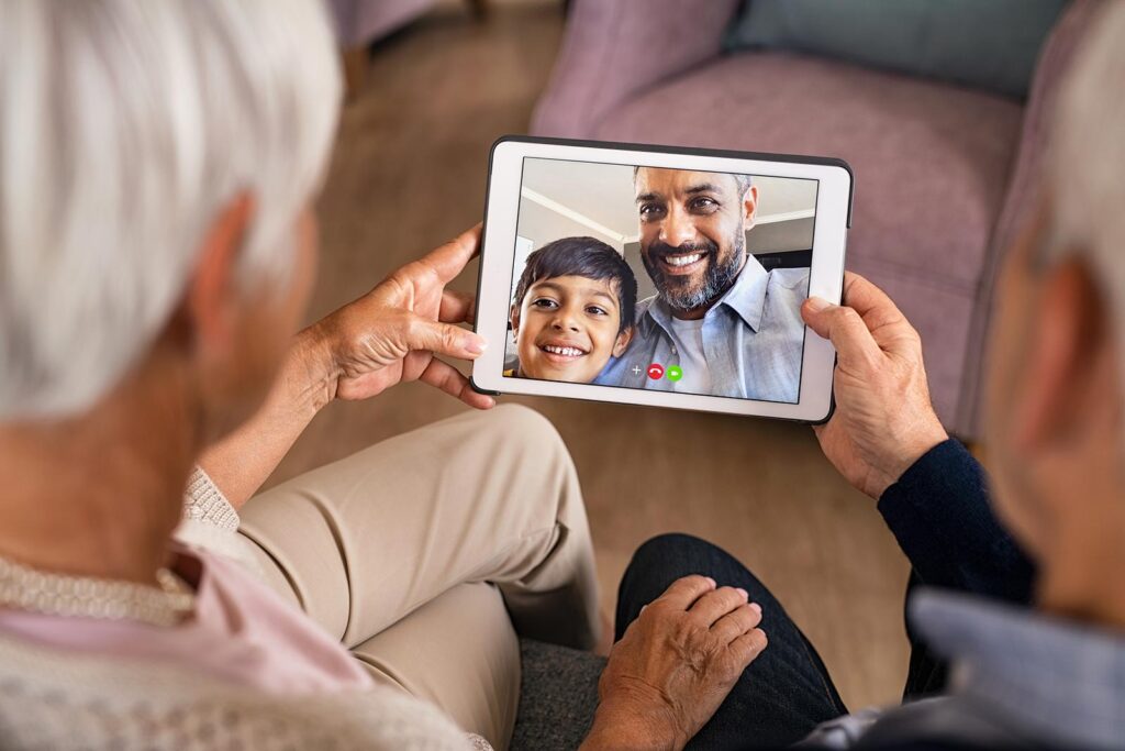 An older couple see their relatives during a video call on a tablet