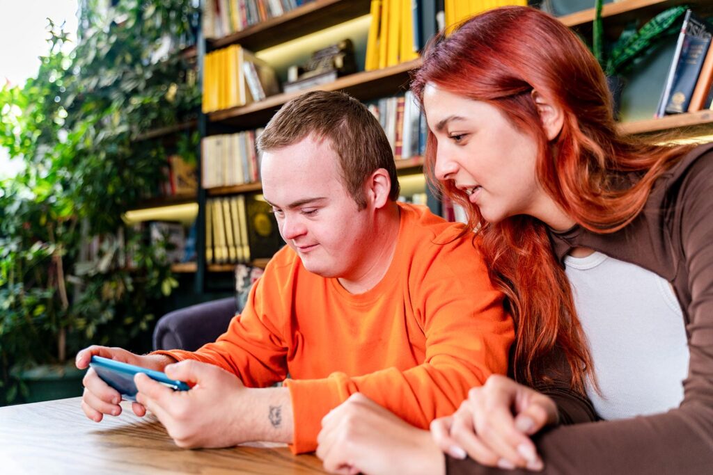 young man with a disability with with his digital mentor